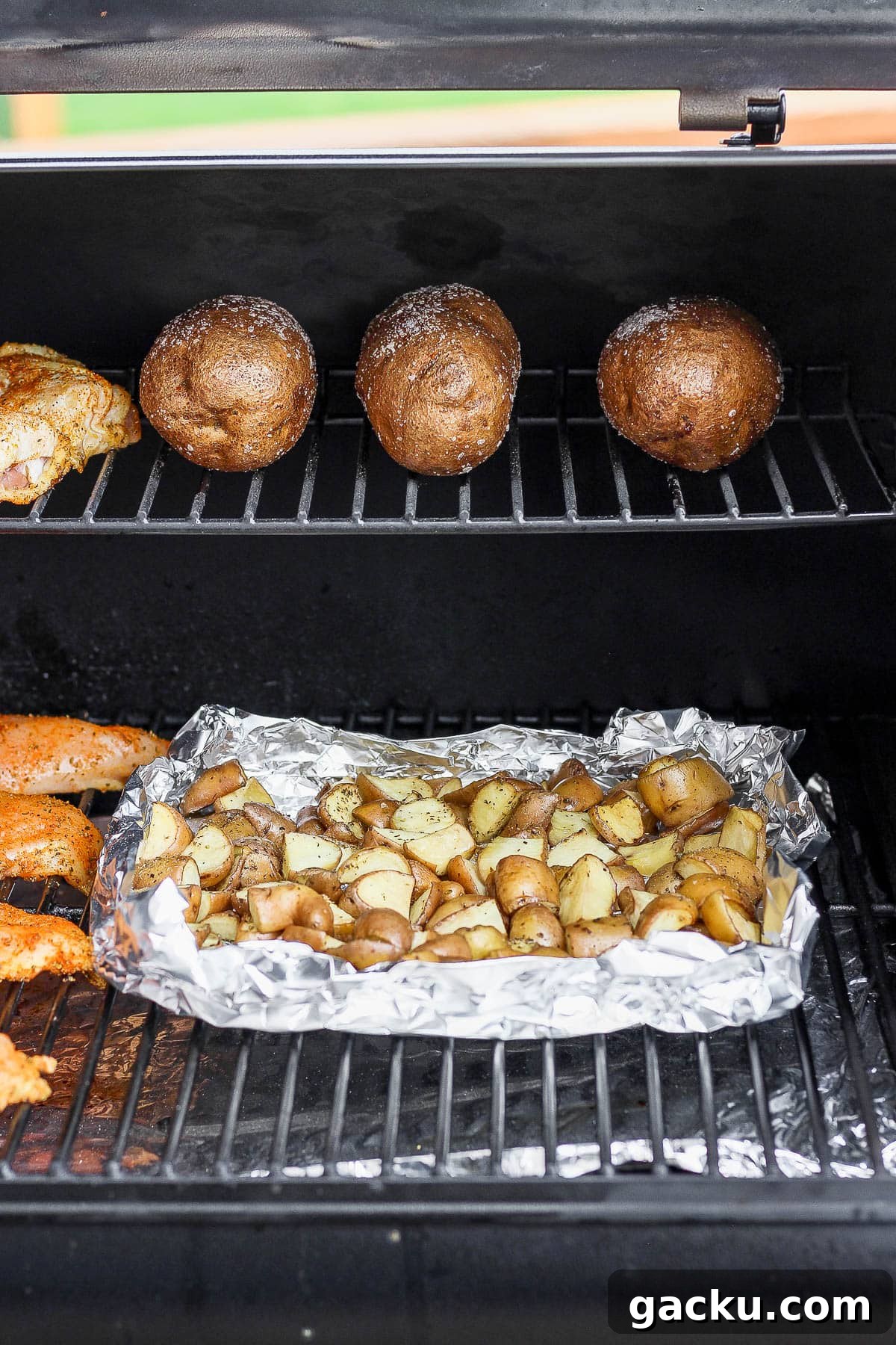 Smoked Potatoes Recipe: Crispy, Smoky Sides from the Grill 2 Cubed smoked potatoes in a foil pan on the smoker.