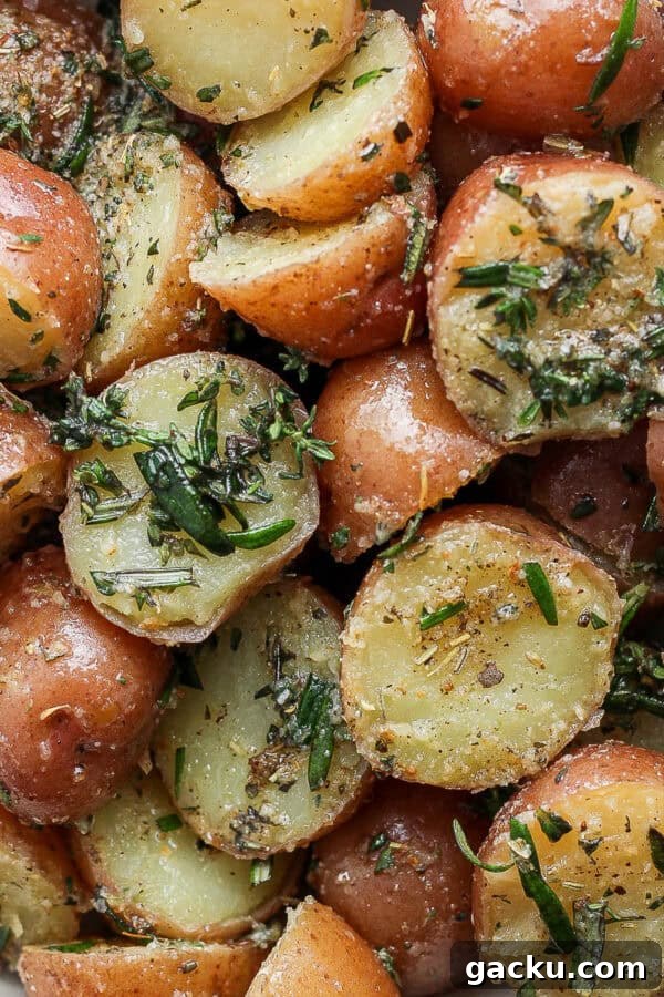 Smoked Potatoes Recipe: Crispy, Smoky Sides from the Grill 11 Close up shot of a bowl of boiled potatoes with herbs.