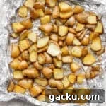Smoked potatoes on an aluminum foil pan after being smoked.