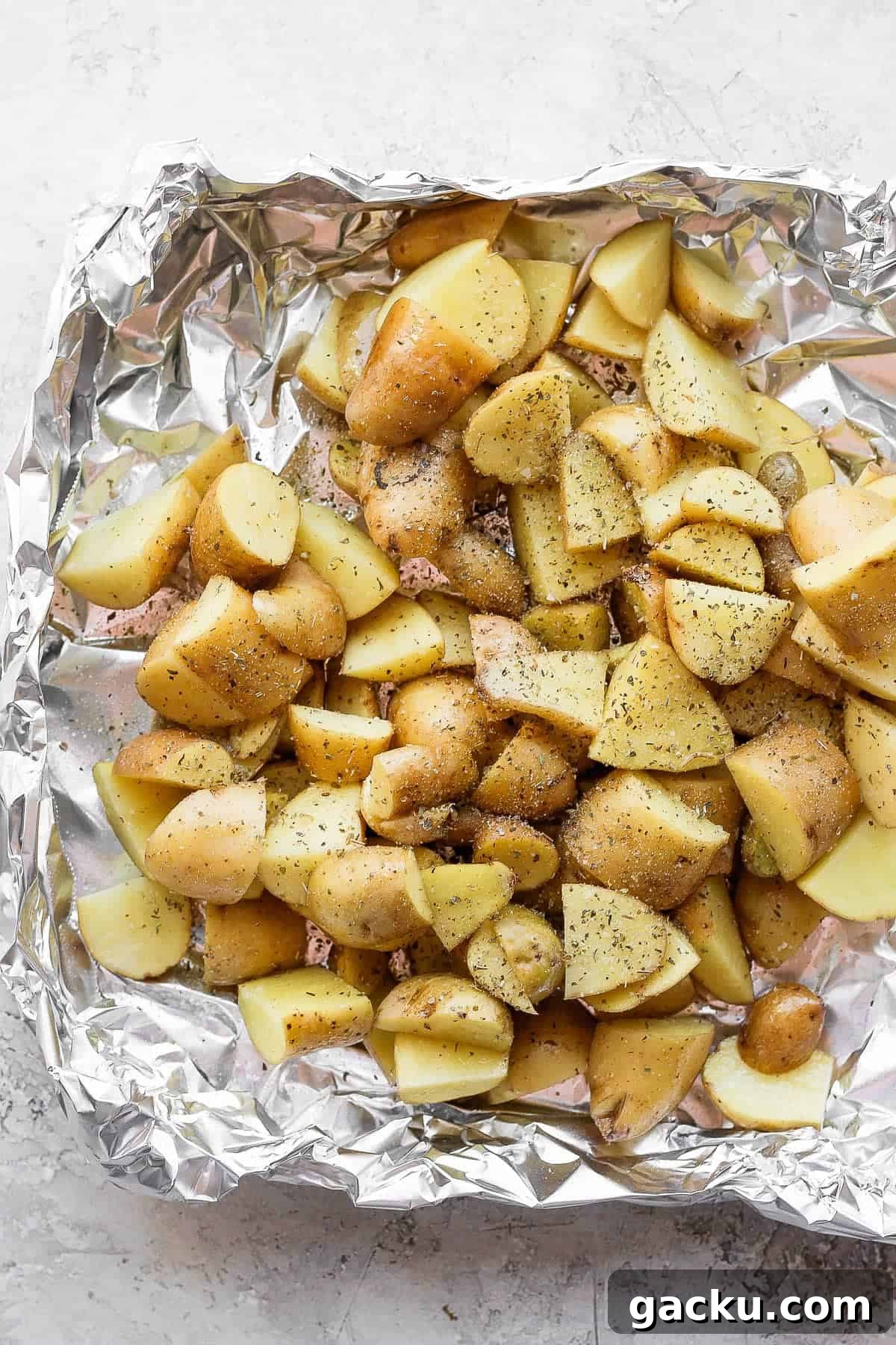 Smoked Potatoes Recipe: Crispy, Smoky Sides from the Grill 5 Seasoned potatoes in a foil pan before going on the smoker.