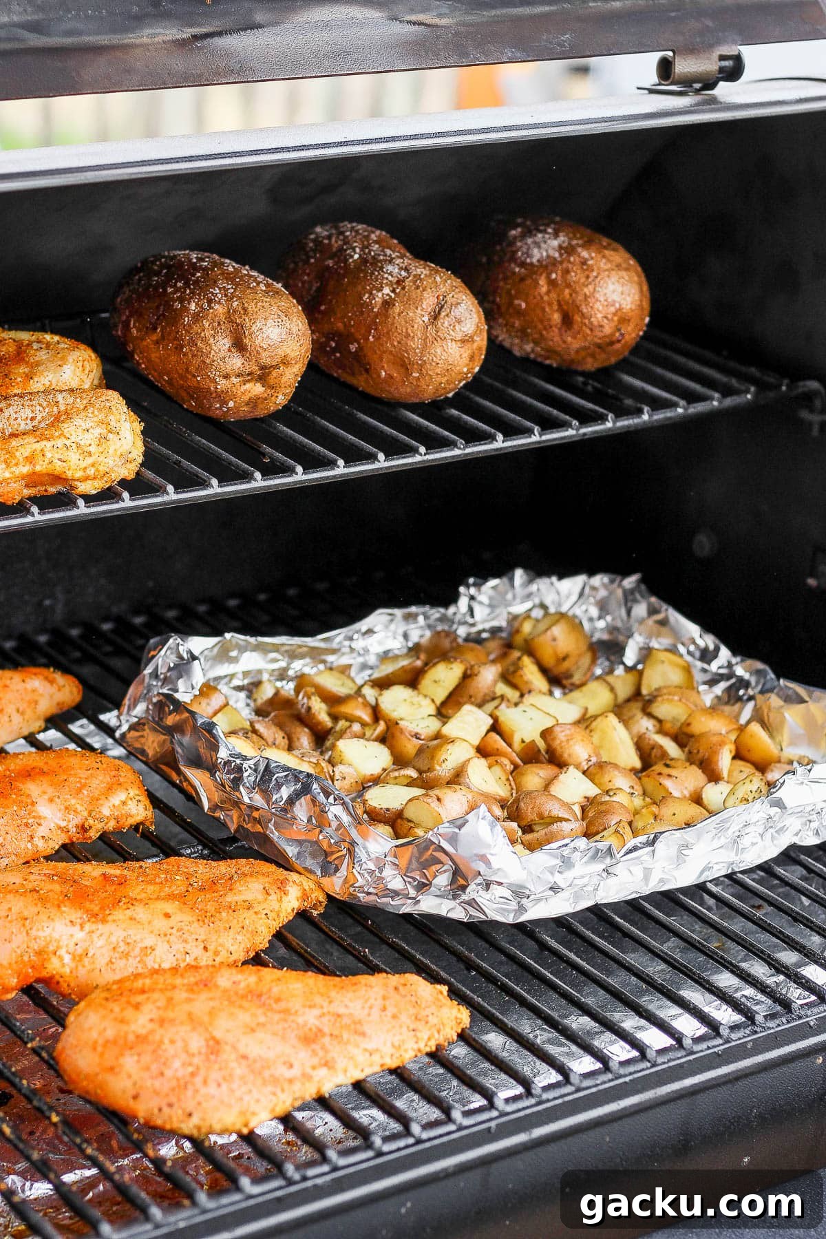Smoked Potatoes Recipe: Crispy, Smoky Sides from the Grill 7 Smoked potatoes in a foil pan on the smoker.