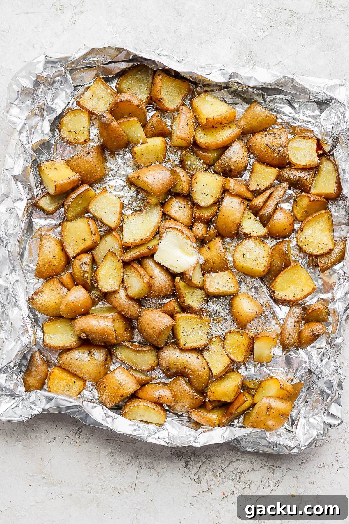 Smoked Potatoes Recipe: Crispy, Smoky Sides from the Grill 8 Smoked potatoes in a foil pan after coming off the smoker.