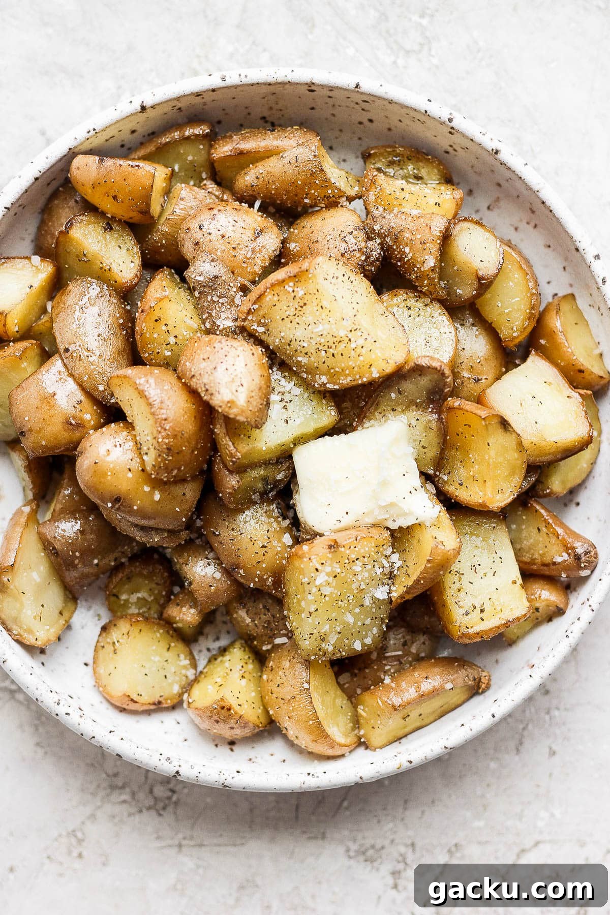 Smoked Potatoes Recipe: Crispy, Smoky Sides from the Grill 9 Smoked potatoes in a bowl with butter.