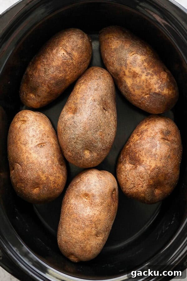 Smoked Potatoes Recipe: Crispy, Smoky Sides from the Grill 10 Top down shot of a slow cooker filled with baked potato.