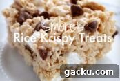 A s'more Rice Krispy treat on a small plate with the text S'mores Rice Krispy Treats overlaid and centered on the photo.
