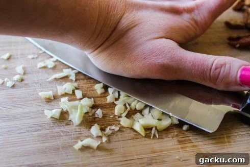 Smashing garlic smashing garlic on a wooden cutting board.