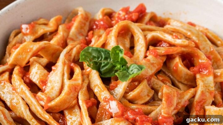 Gluten-free pasta in a bowl with pasta sauce.