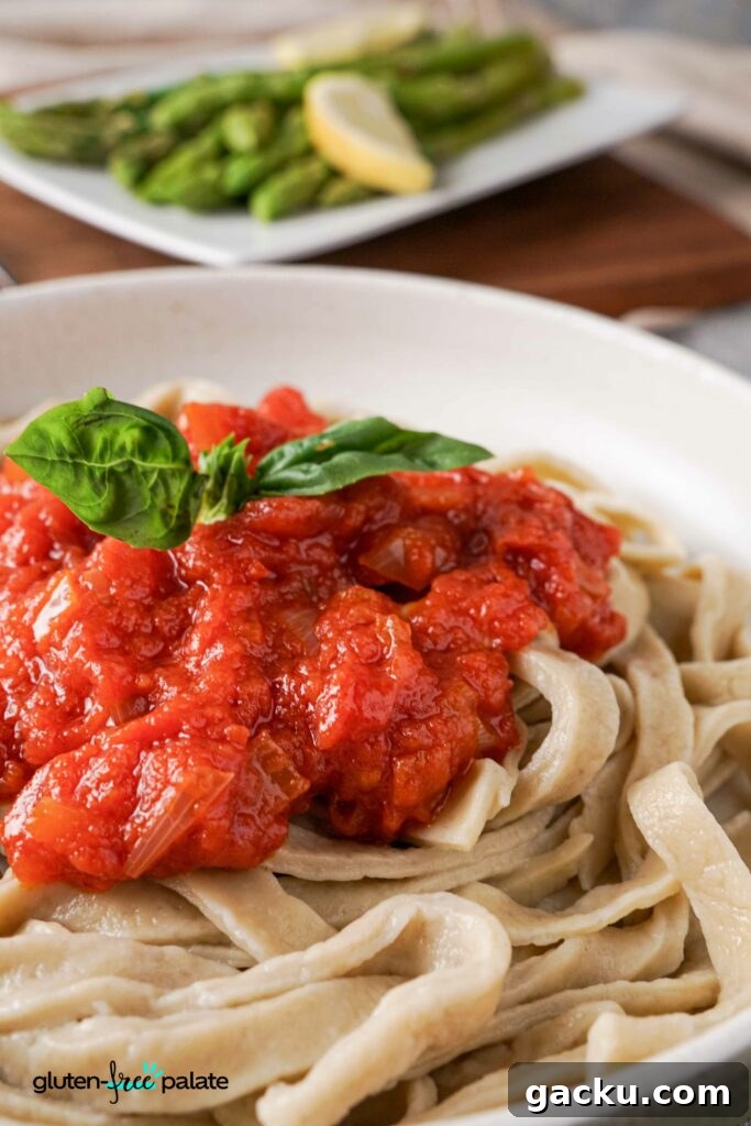 Homemade Gluten-Free Pasta Recipe—No Machine Needed 4 Close up view of Gluten-free pasta in a bowl with pasta sauce.