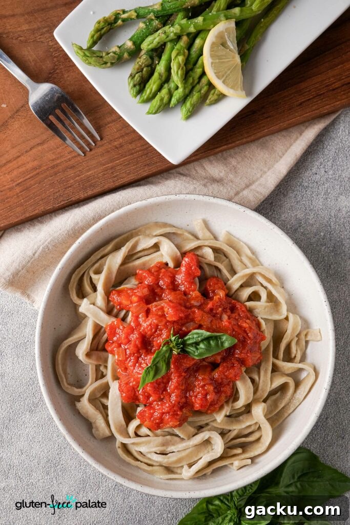 Homemade Gluten-Free Pasta Recipe—No Machine Needed 8 Gluten-free pasta in a bowl with red pasta sauce.