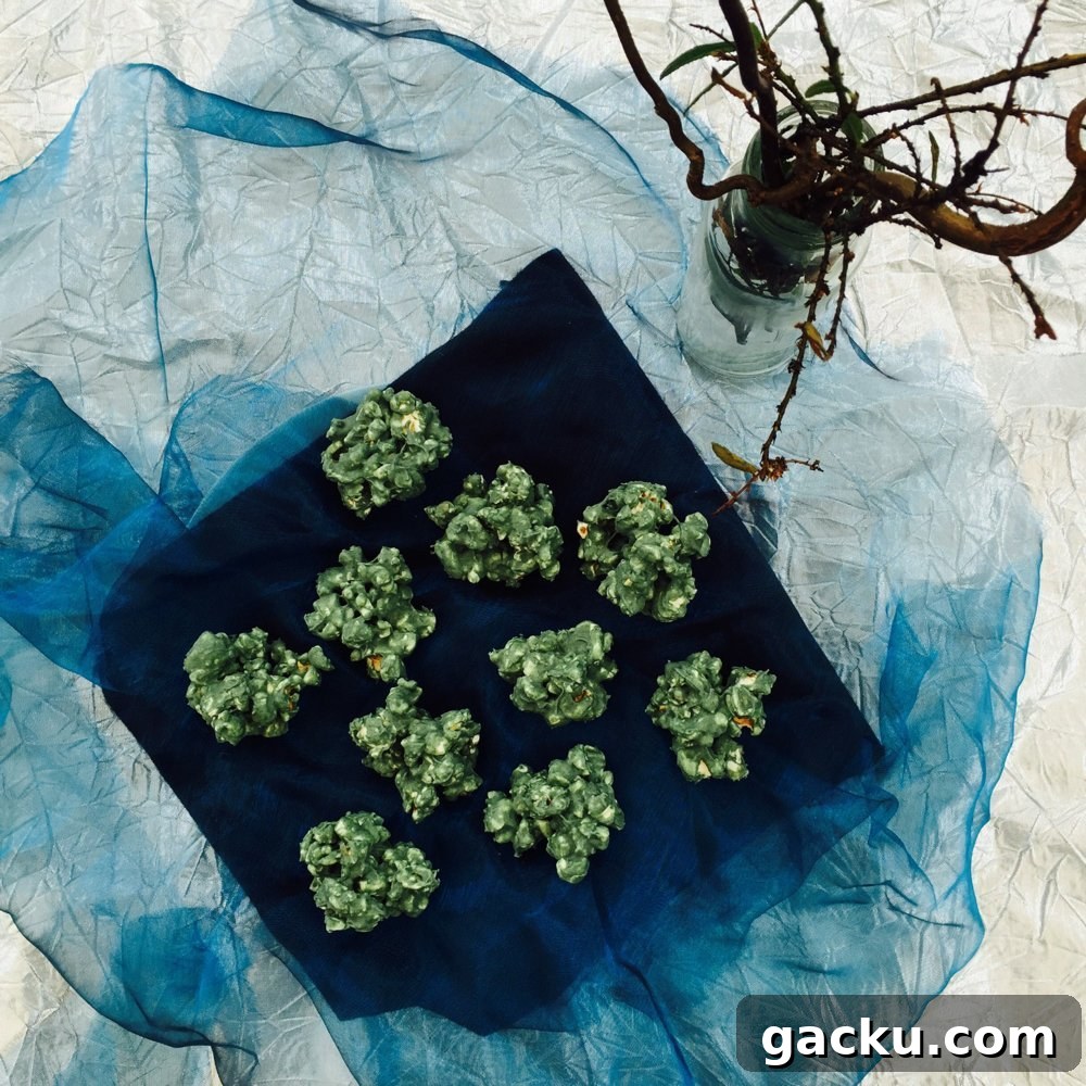 green chocolate cakes on blue netting with dead twigs in the background