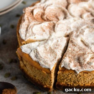 A sliced, whole spiced pumpkin cheesecake.