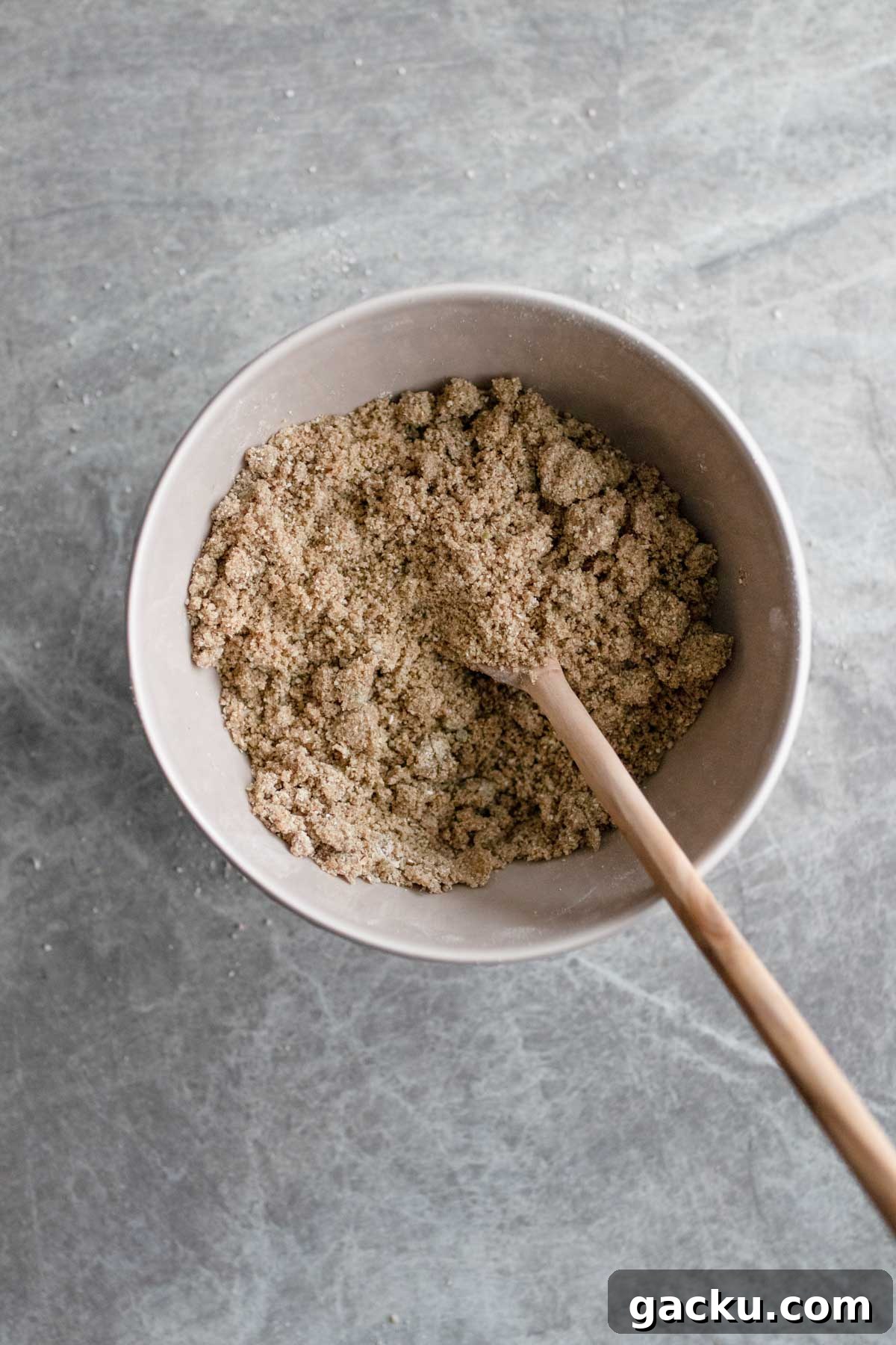 Mixing the oatmeal pepita crust for cheesecake.