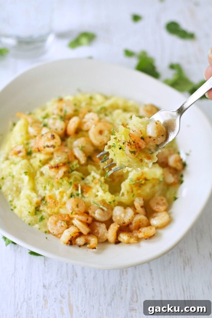 Slow Cooker Spaghetti Squash with shrimp in white bowl with fork