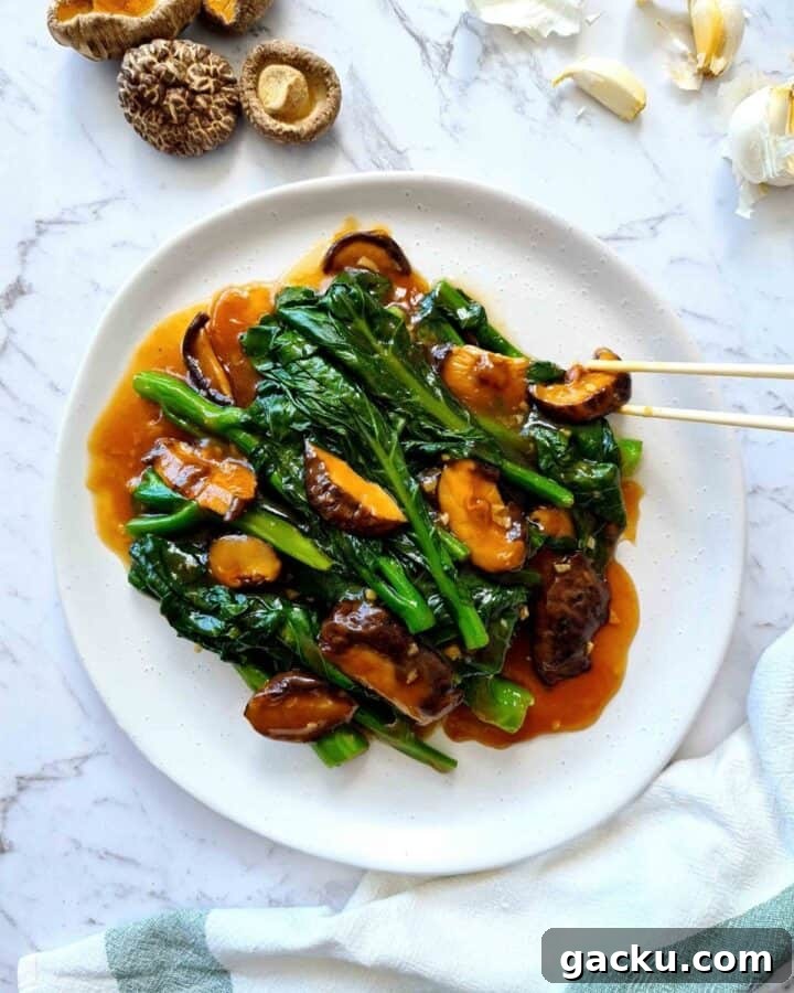 Chinese Broccoli Stir-Fry with Oyster Sauce and Shiitake Mushrooms 6 A plate of finished dish being served