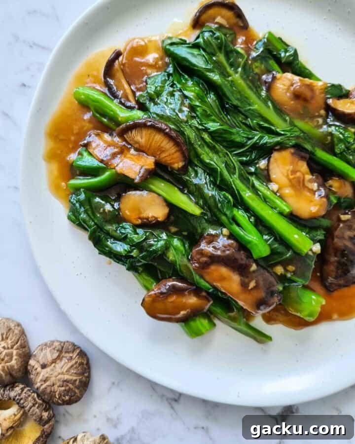 Chinese Broccoli Stir-Fry with Oyster Sauce and Shiitake Mushrooms 7 Close up of Chinese broccoli with shiitake mushrooms on top left corner