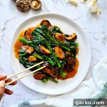 Chinese Broccoli Stir-Fry with Oyster Sauce and Shiitake Mushrooms 8 Plate of Chinese broccoli with mushrooms and sauce