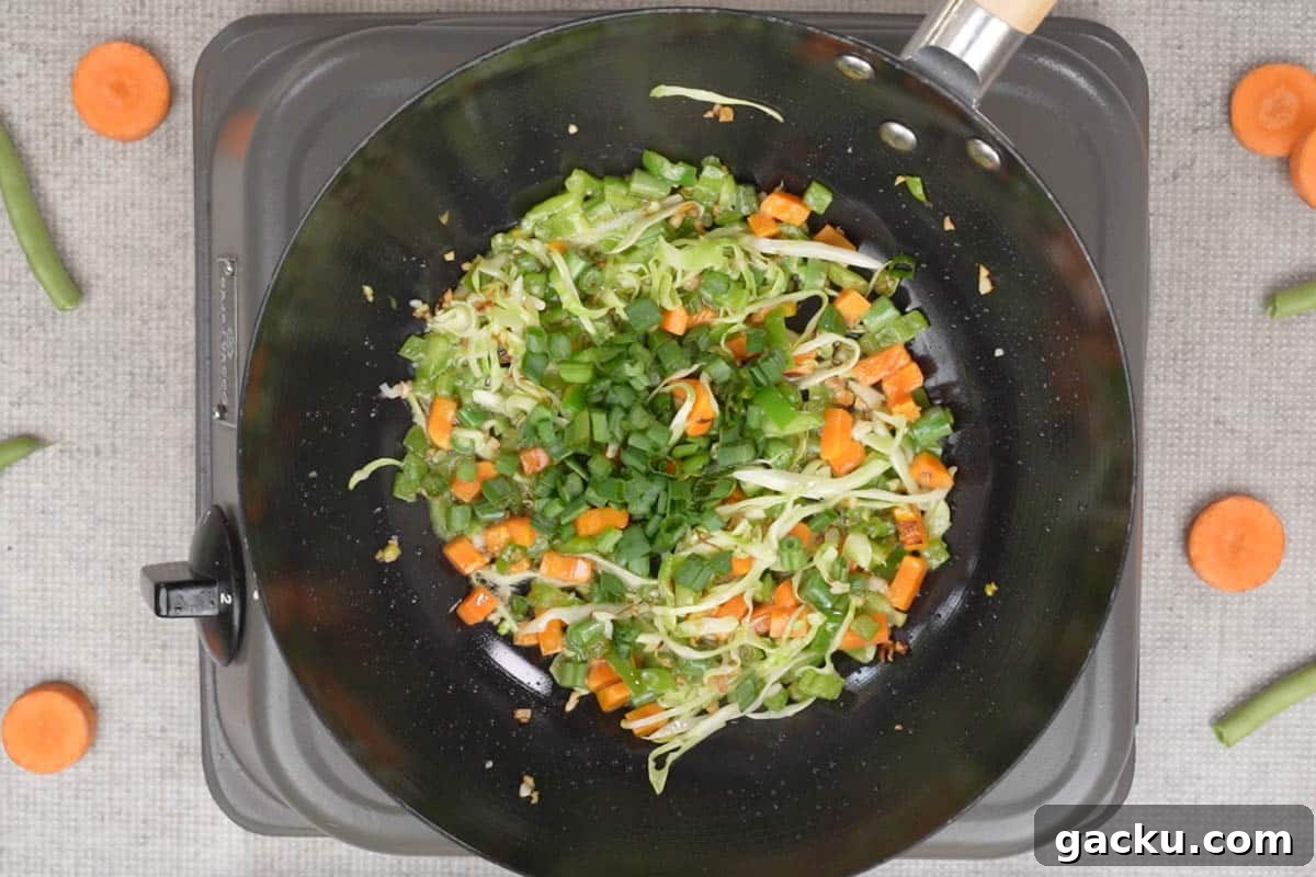 Spring onion greens added to the wok.