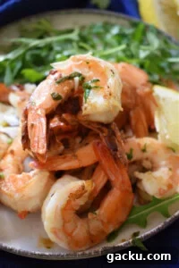Zesty Lemon Skillet Shrimp Recipe — Quick Pan-Seared Shrimp 15 a pile of zesty lemon shrimp on a plate.