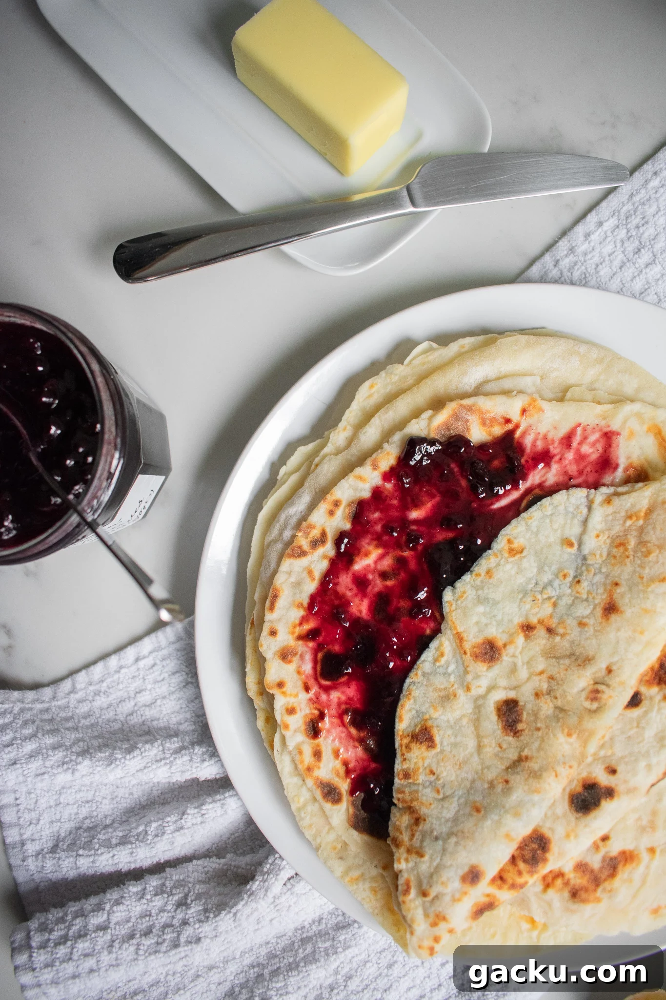 How to Make Traditional Norwegian Lefse: Potato Flatbread Recipe 3 Potato pancakes on a plate with jam
