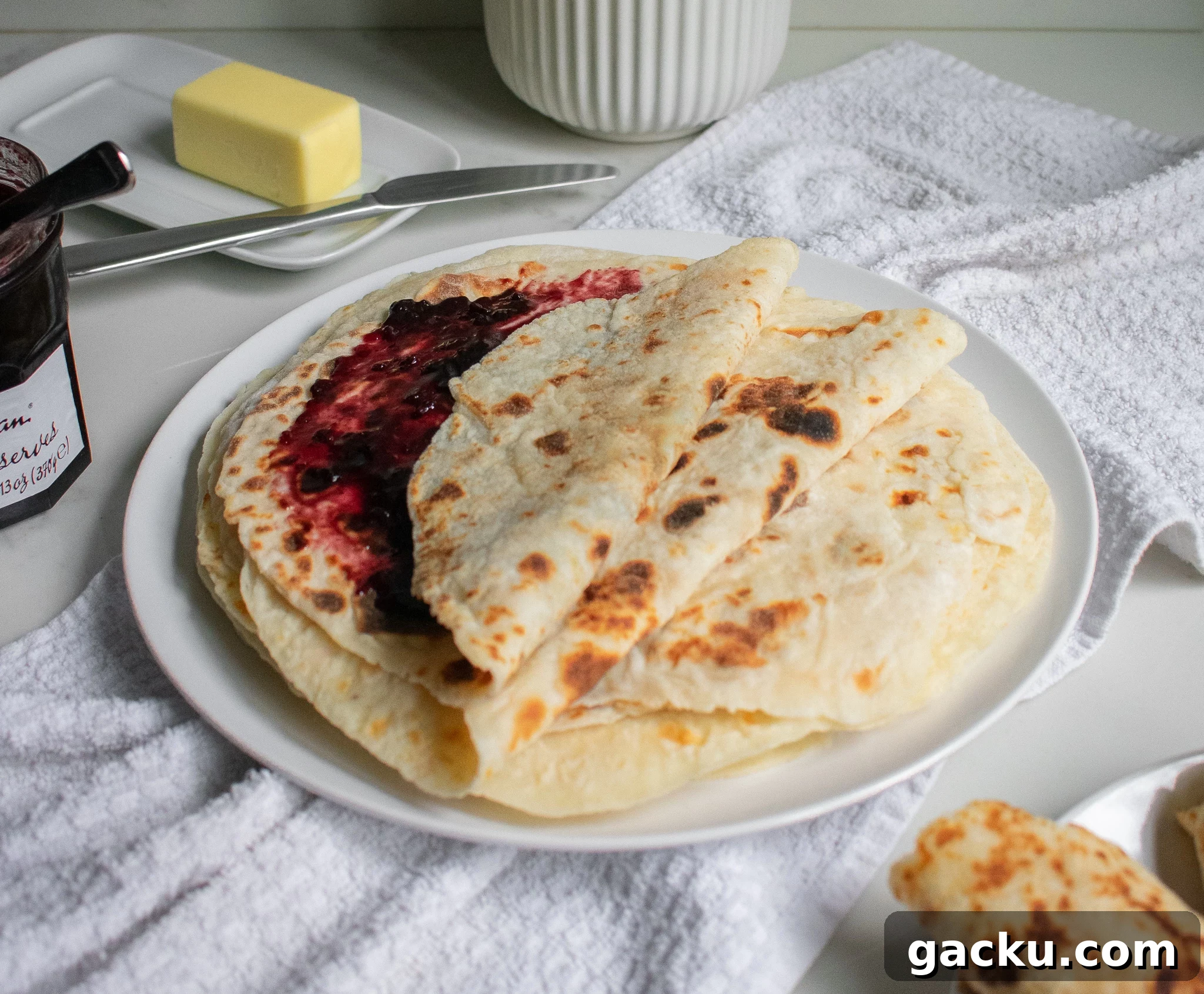 How to Make Traditional Norwegian Lefse: Potato Flatbread Recipe 4 Potato pancakes on a plate with jam