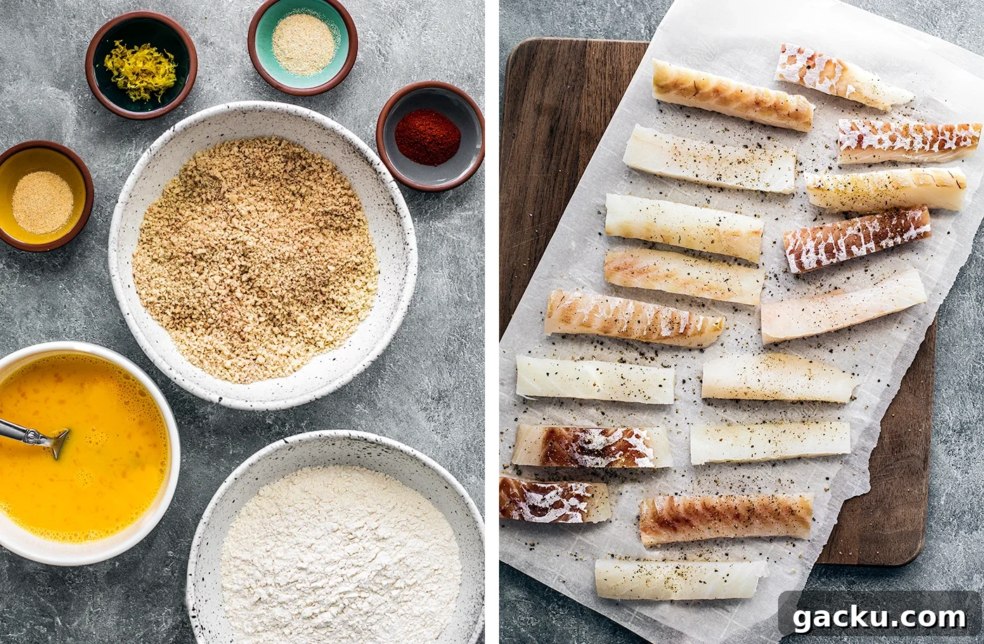 Bowls of ingredients for breading the fish sticks as well as unbreaded, uncooked fish sticks in a serving board.