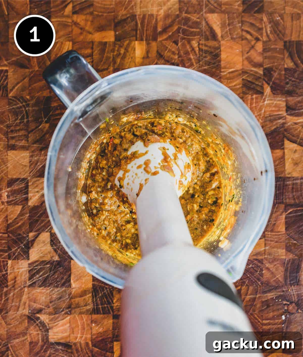 Blending the marinade ingredients using an immersion blender for Thai-Style Grilled Chicken (Gai Yang)