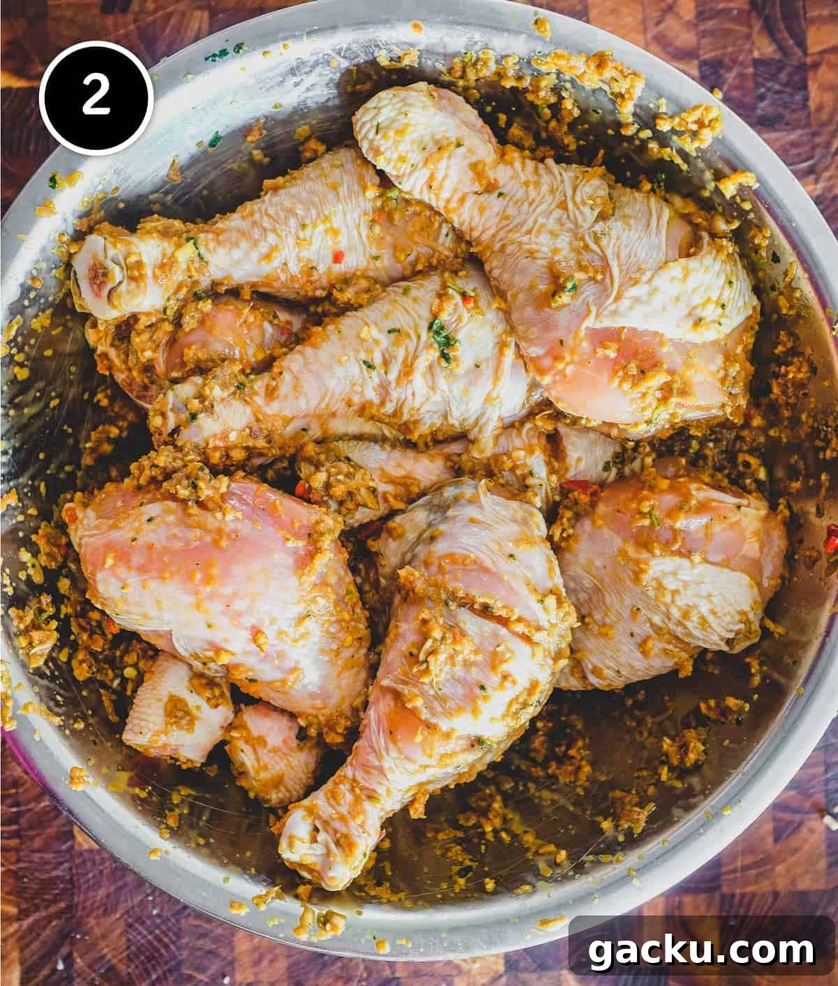 Chicken marinating in various Thai ingredients for Thai-Style Grilled Chicken (Gai Yang)