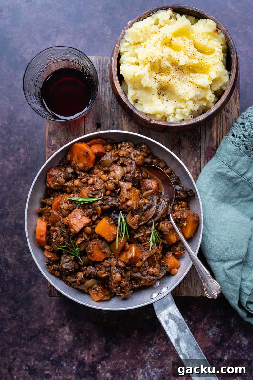 Comforting Vegan Lentil and Root Vegetable Stew 2 Hearty vegetable stew in a small pan with mashed potatoes on the side