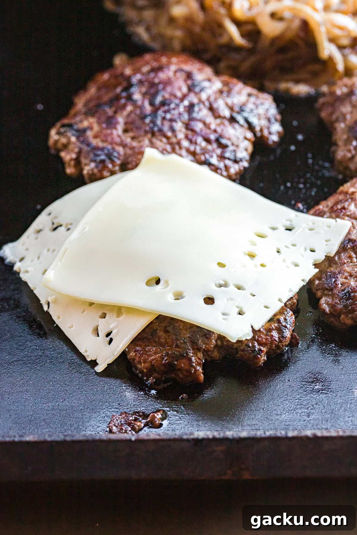 Perfect Blackstone Patty Melt Recipe: Juicy, Griddled Sandwich 11 Adding cheese to burger patties for Patty Melt on Blackstone