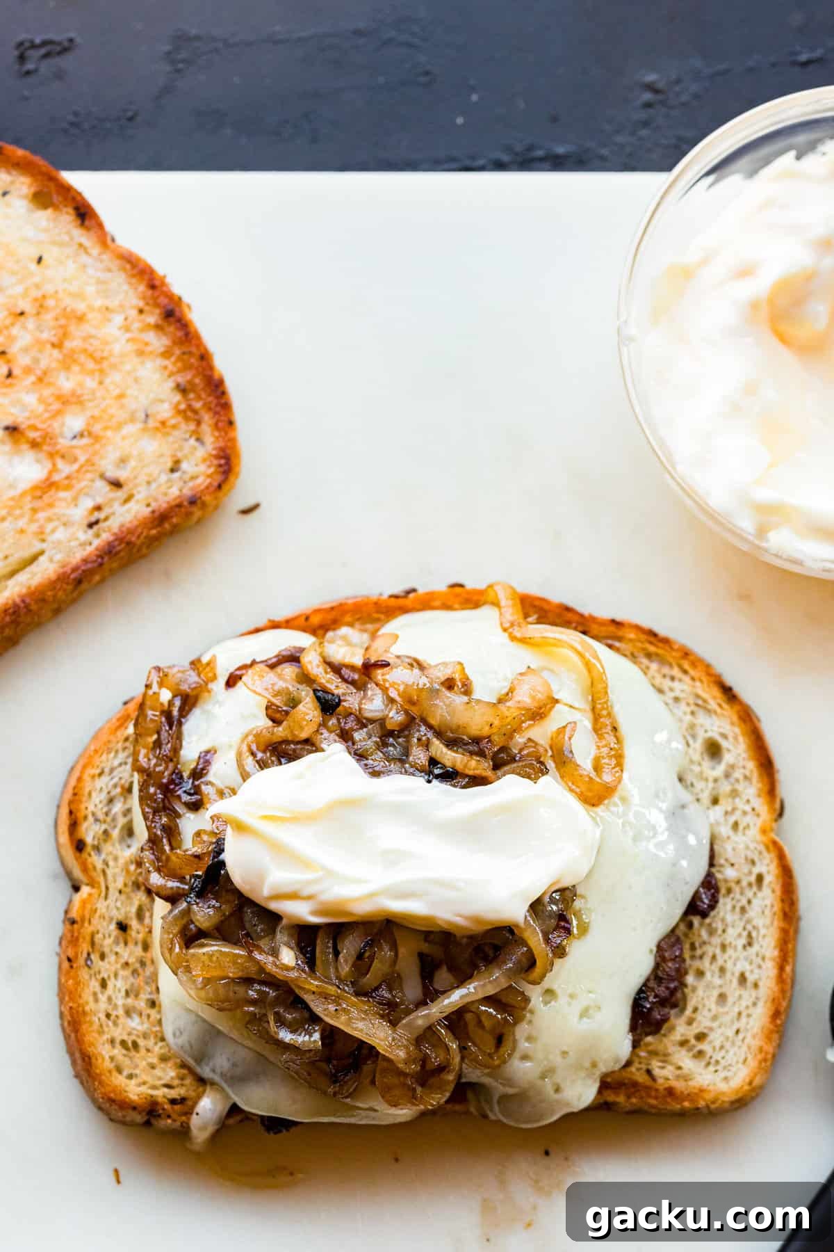 Perfect Blackstone Patty Melt Recipe: Juicy, Griddled Sandwich 12 Adding patty melt ingredients to grilled bread for Blackstone Patty Melts