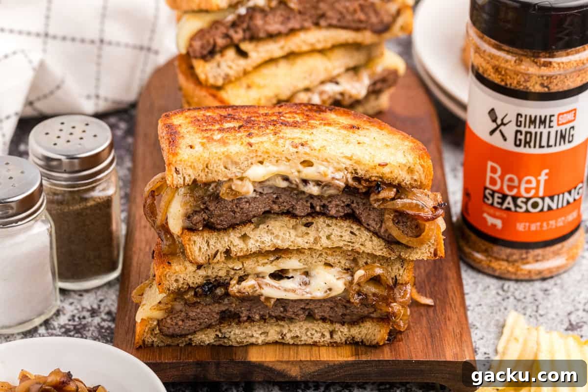 Perfect Blackstone Patty Melt Recipe: Juicy, Griddled Sandwich 14 Blackstone Patty Melts cut and stacked on cutting board