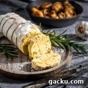 Roasted Garlic Butter Recipe for Homemade Bread, Steak & Veggies 6 Roasted garlic butter in a sausage shape in a wooden plate.