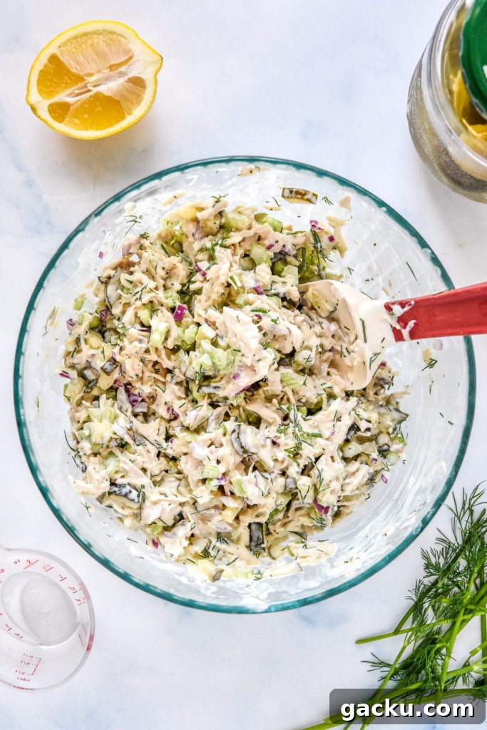 Dill Pickle Chicken Salad Recipe with Crunchy Celery & Herbs 8 dill pickle chicken salad mixed up in a large glass bowl.