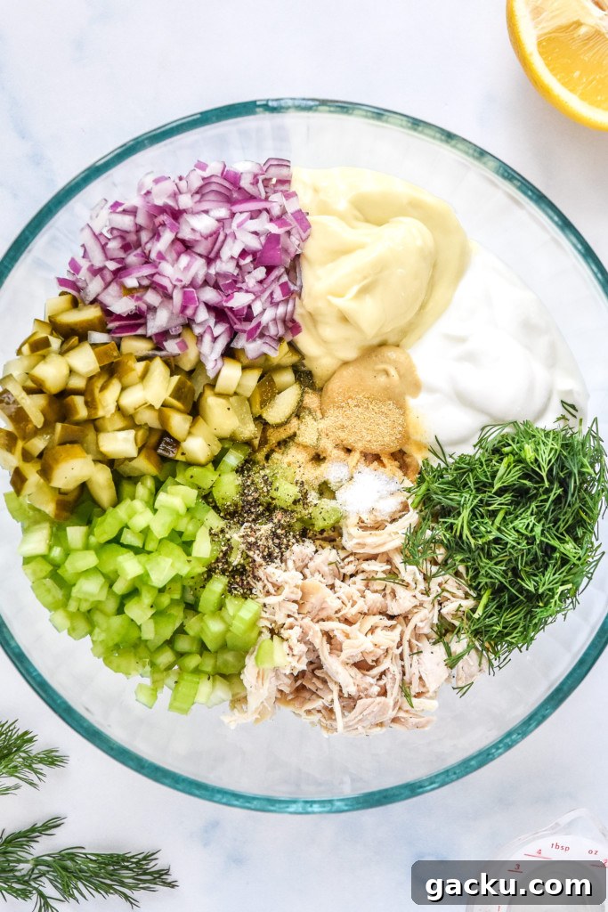 Dill Pickle Chicken Salad Recipe with Crunchy Celery & Herbs 7 all ingredients for the dill pickle chicken salad in a large glass mixing bowl.