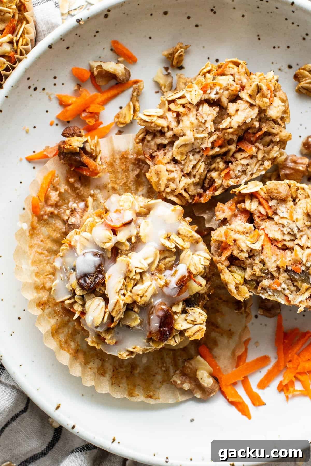 Carrot Cake Oatmeal Muffins: Spiced Breakfast Cups with Raisins and Nuts 2 A plate with granola muffins on it.