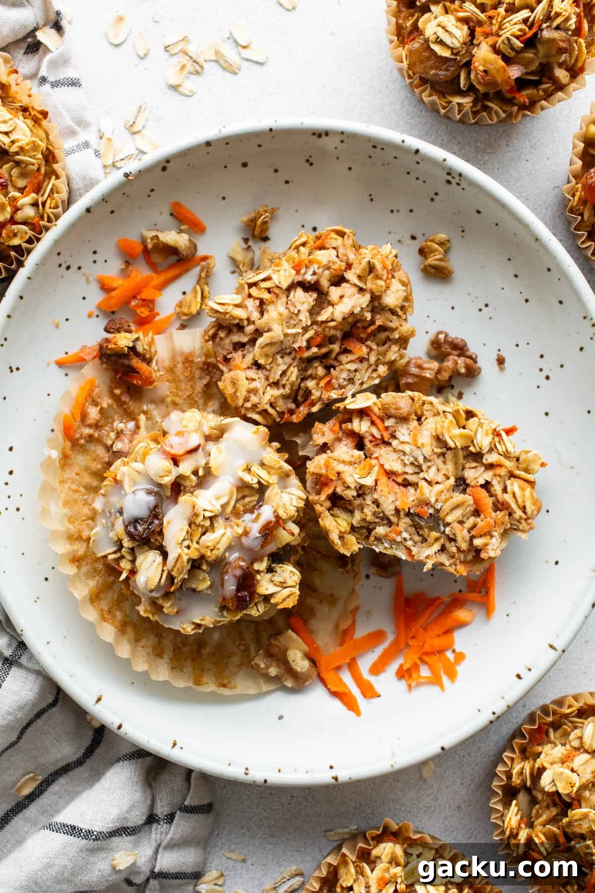 Carrot Cake Oatmeal Muffins: Spiced Breakfast Cups with Raisins and Nuts 6 Carrot granola muffins on a plate.