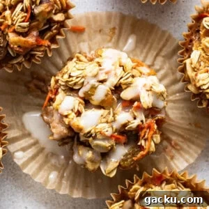 Carrot Cake Oatmeal Muffins: Spiced Breakfast Cups with Raisins and Nuts 7 A group of muffins with granola and carrots.