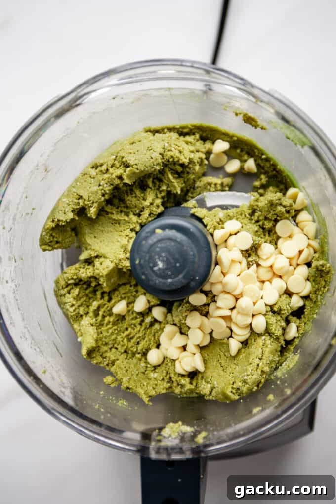 Energizing Matcha Energy Bites for Sustained Focus 5 matcha energy balls dough and white chocolate chips in a food processor
