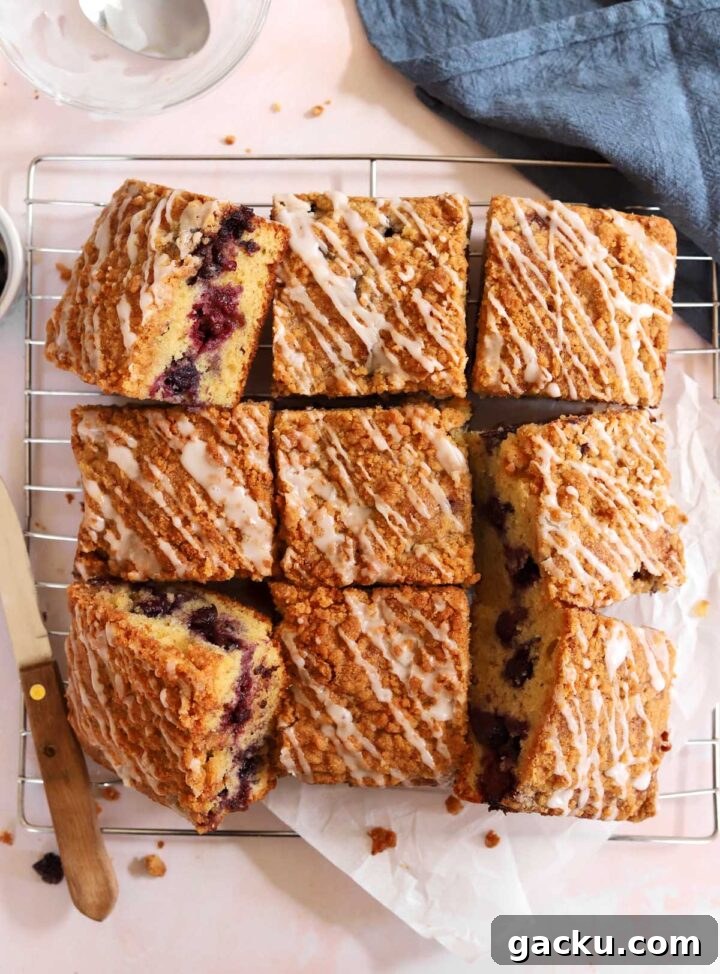 Blueberry Sour Cream Coffee Cake Recipe — Moist, Tender Slice 6 blueberry sour cream coffee cake sliced on cooling rack