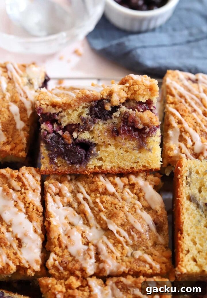 Blueberry Sour Cream Coffee Cake Recipe — Moist, Tender Slice 7 blueberry sour cream coffee cake sliced