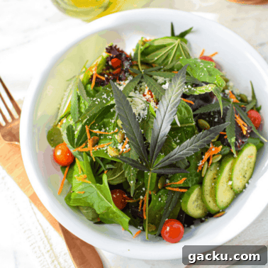 A picture of a salad topped with a cannabis leaf.