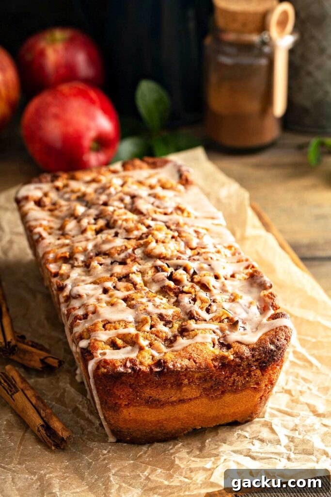 Cinnamon Apple Quick Bread Recipe for Moist, Spiced Loaf 11 A loaf of apple bread with cinnamon sugar topping and drizzles with cinnamon glaze.