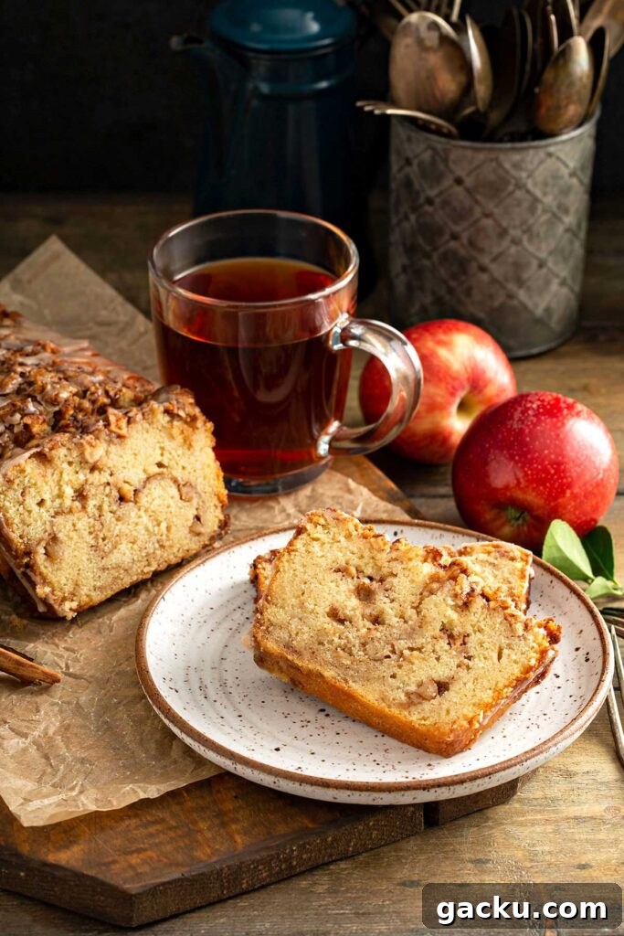 Cinnamon Apple Quick Bread Recipe for Moist, Spiced Loaf 12 slices of warm cinnamon apple bread served on a white plate