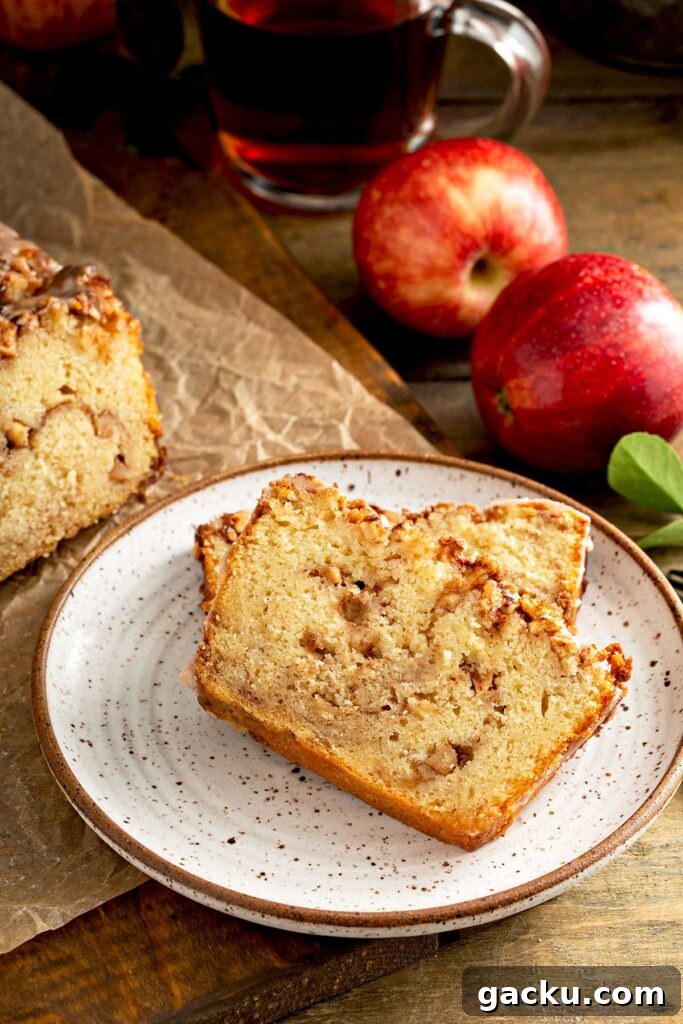 Cinnamon Apple Quick Bread Recipe for Moist, Spiced Loaf 9 Two slices of apple bread on a white plate