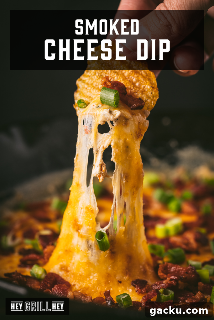Skillet Bacon and Smoked Cheese Dip Recipe 2 Smoked cheese dip on a corn tortilla chip with text overlay - Smoked Cheese Dip.