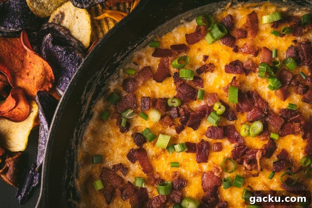Skillet Bacon and Smoked Cheese Dip Recipe 5 Smoked cheese dip in a cast iron skillet topped with bacon and green onions.
