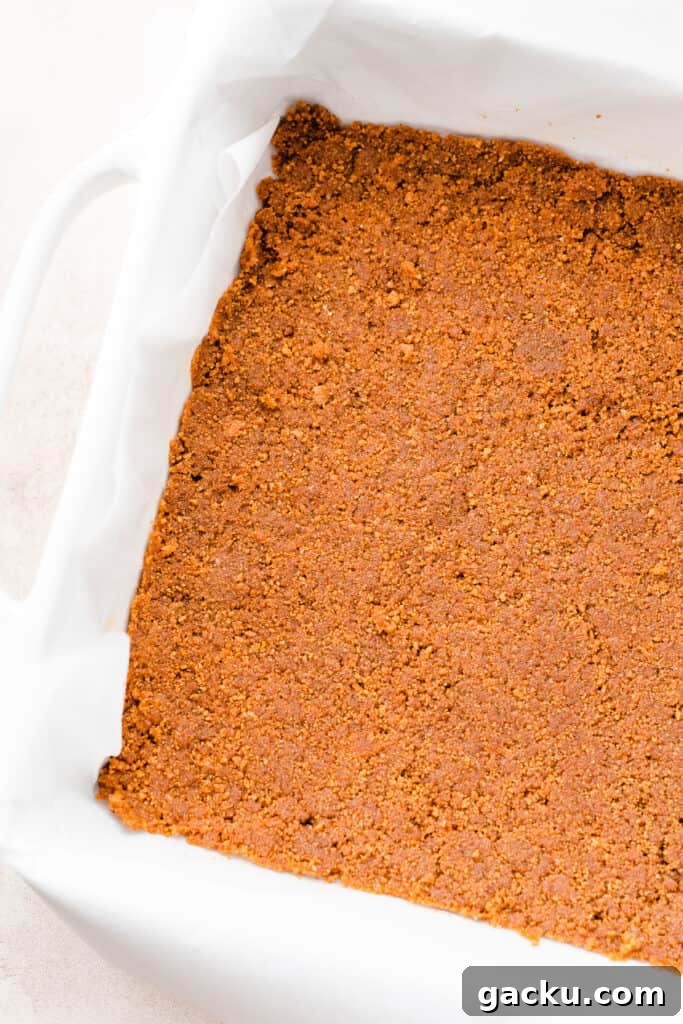 Irish Cream Pumpkin Cheesecake Bars Recipe for Fall Desserts 4 The baked crust in a 9x9 pan.