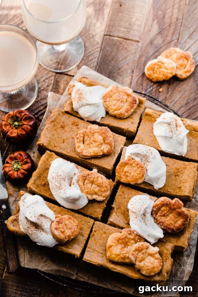 Irish Cream Pumpkin Cheesecake Bars Recipe for Fall Desserts 9 A birds eye view of the sliced pumpkin bars on a wooden surface.