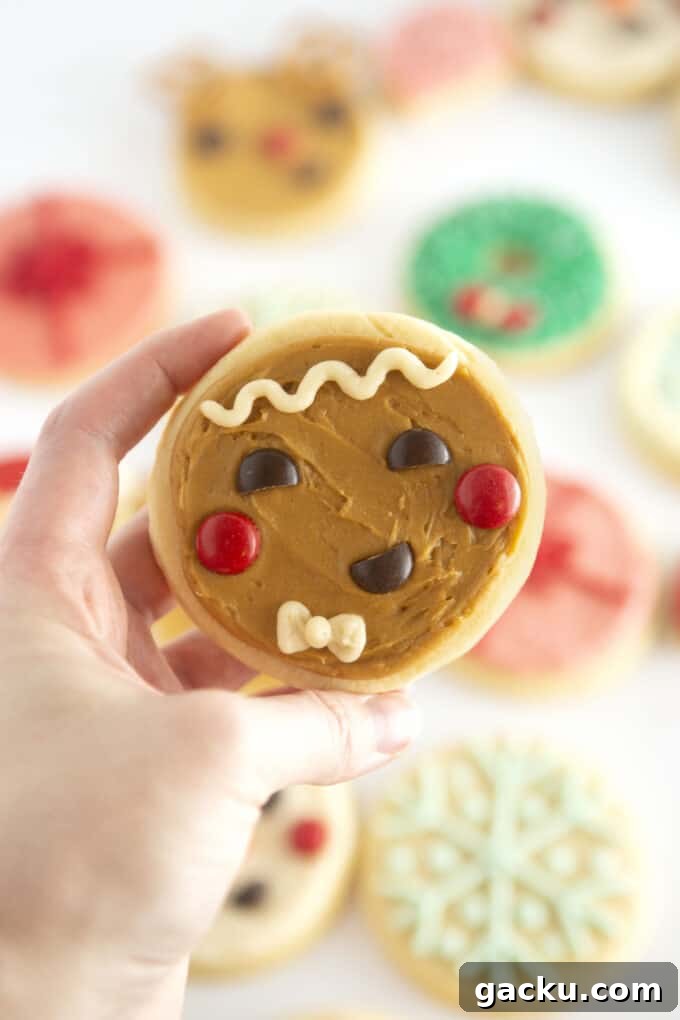 Circle Gingerbread Man Sugar Cookies — Festive Round Cookie Recipe 3 hand holding brown gingerbread man face cookie