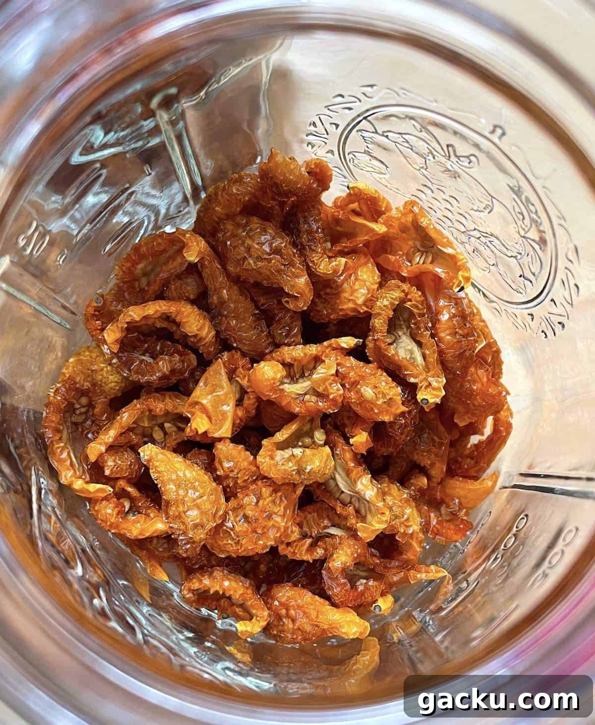 Dehydrating Cherry Tomatoes: Step-by-Step Guide for Perfect Results 13 A glass jar filled with dehydrated sun gold tomatoes.